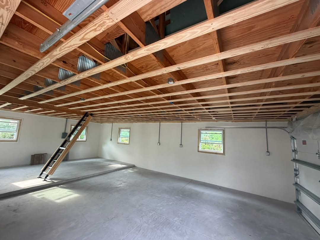 Garage ceiling stripped to framing before drywall replacement