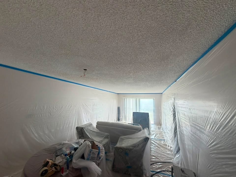 Living room masked off with popcorn ceiling still in place