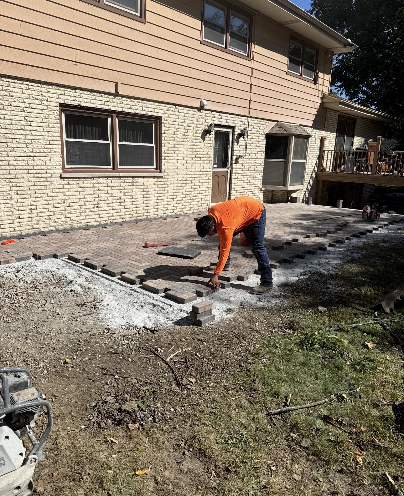 Adan's Landscaping crew installing a paver patio